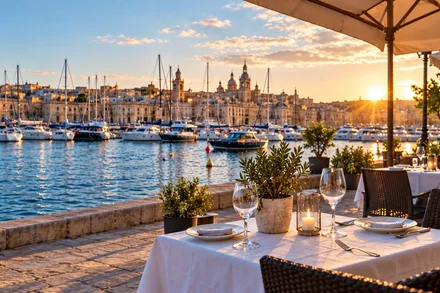 A harbour at golden hour with stone quays and moored boats