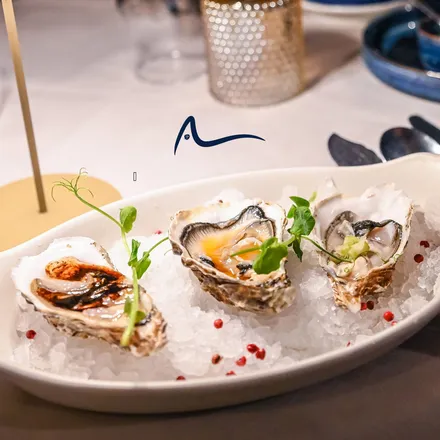 Three dressed oysters on crushed ice
